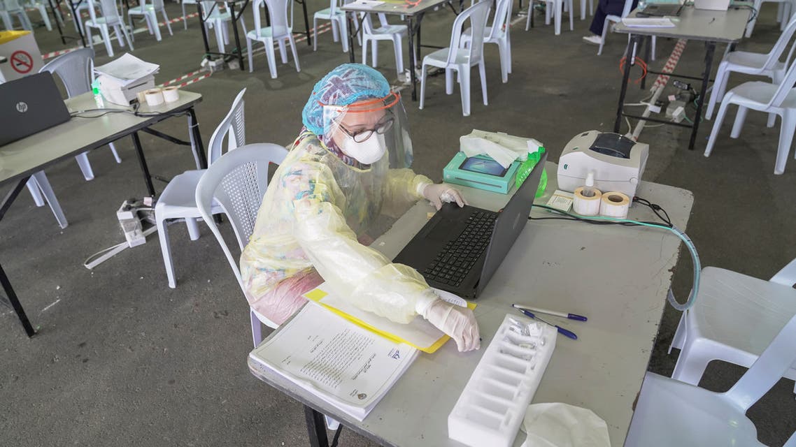 A Kuwaiti doctor prepares her station ahead of the arrival of a planeload of repatriated Kuwaiti citizens at a makeshift field testing center, following the outbreak of the coronavirus disease (COVID-19), at Kuwait Airport, Kuwait April 21, 2020. REUTERS/Stephanie McGehee