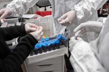 Mirimus, Inc. lab scientists sort through COVID-19 samples from recovered patients on April 10, 2020 in the Brooklyn borough of New York City. (AFP)