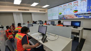 Employees of the COVID-19 coronavirus disease operations room of the Saudi Red Crescent (SRC) are seen while on duty in the Saudi capital Riyadh, on April 6, 2020. The SRC increased their employees to meet the increased demand on ambulances since the novel coronavirus appeared and the kingdom imposed a curfew.