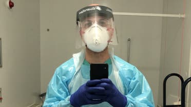 Hassan Akkad takes a selfie in scrubs and protective gear as he works as a cleaner at the Whipps Cross University Hospital, amid the coronavirus disease (COVID-19) outbreak in London, Britain April 7, 2020. Hassan Akkad/Handout via REUTERS ATTENTION EDITORS - THIS IMAGE HAS BEEN SUPPLIED BY A THIRD PARTY. NO RESALES. NO ARCHIVES