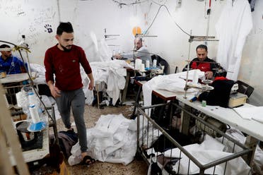 Palestinians make protective overalls to help shield people from the coronavirus, that will be exported to Israel, at a local factory, in Gaza City, Monday, March 30, 2020. (AP)