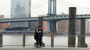 Pedestrians wearing masks walk in Brooklyn Bridge Park as the spread of the coronavirus disease (COVID-19) outbreak continues in the Brooklyn borough of New York City. (Reuters)
