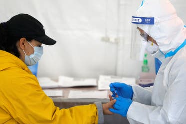 A healthcare worker performs a coronavirus antibody test at a walk-in testing site in Brooklyn, New York City, New York, on April 24, 2020. (Reuters)