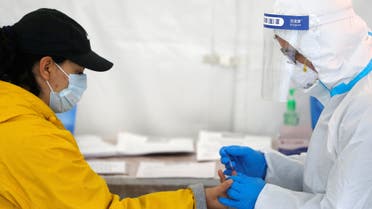 A healthcare worker performs a coronavirus antibody test at a walk-in testing site in Brooklyn, New York City, New York, on April 24, 2020. (Reuters)
