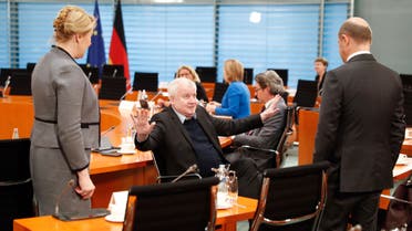 German Interior Minister Horst Seehofer, center, gestures to Finance Minister Olaf Scholz, right, and Minister for Family Affairs, Senior Citizens, Women and Youth Franziska Giffey in Berlin, Germany on March 23, 2020. (AP)