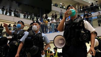 Police break up pro-democracy singing protest at mall in Hong Kong