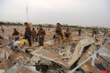 Iraqi army soldiers inspect the destruction at an airport complex under construction in Karbala, Iraq, Friday, March 13, 2020. (AP)