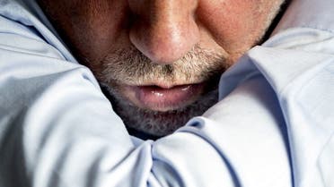 An illustraton picture shows a person Sneezing in the elbow cavity on March 4, 2020. (AFP)
