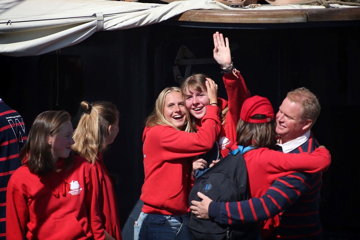 A student hugs a relative as she arrives with her fellows on the sailing ship Wylde Swan at the port of Harlingen, on April 26, 2020 after a journey from the Caribbeans. (AFP)