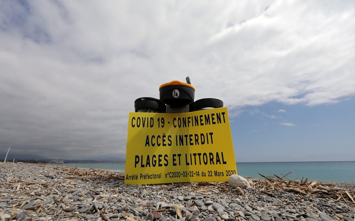 A sign reads “Covid 19 - Lockdown. Forbidden access to beaches and coastline,” near the beach, as a lockdown is imposed to slow the rate of the coronavirus, in Antibes, France. (Reuters)
