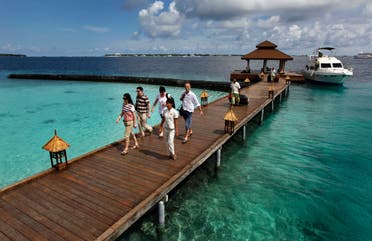 Foreign tourists arrive in a resort in the Kurumba island in Maldives on Feb. 12, 2012. (AP)