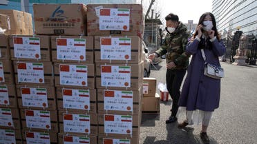 Workers from a charity foundation prepare boxes of disinfectant tablets to be donated to Iran in Beijing on Monday, March 16, 2020. (AP)