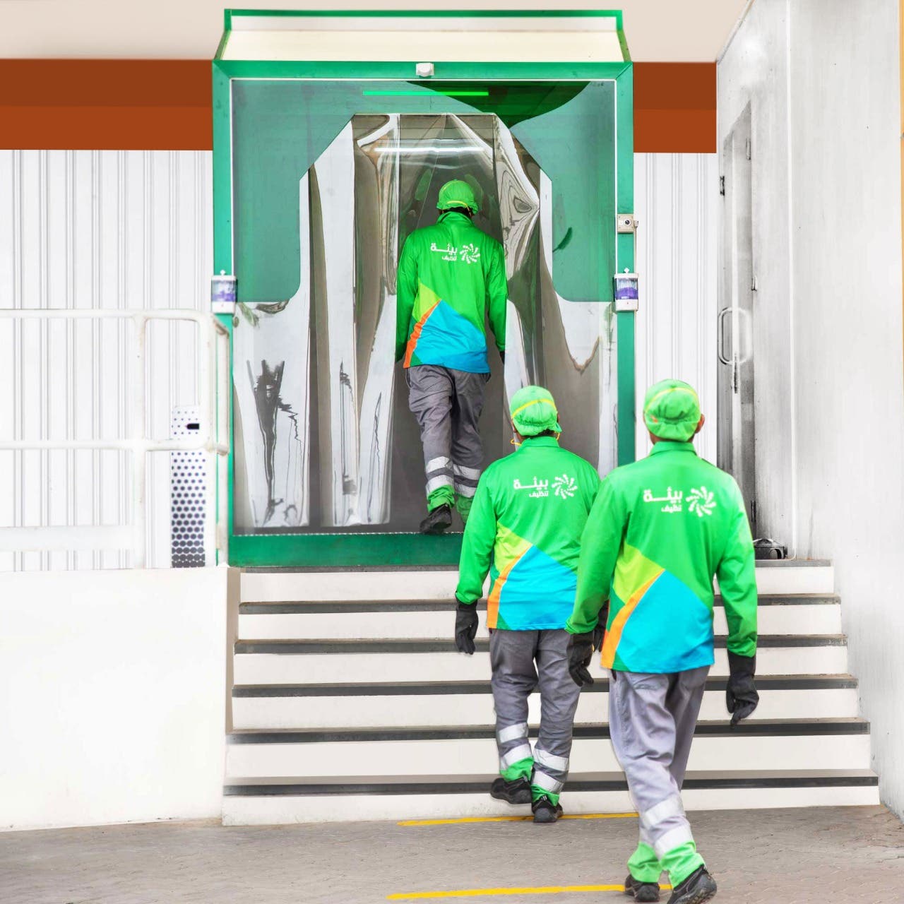 Bee'ah employees enter a disinfection pod, April 27, 2020. (WAM)