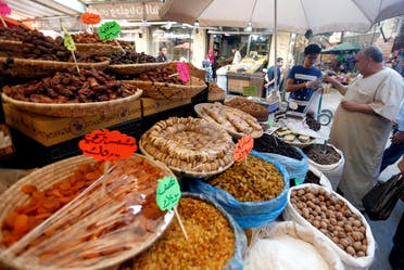 People buy dates for Iftar during the holy month of Ramadan at a market area in Amman. (File photo: Reuters)