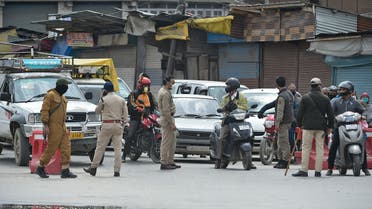 Indian police stops vehicles at a checkpoint during a government-imposed nationwide lockdown as a preventive measure against the COVID-19 coronavirus, in Srinagar on April 20, 2020. 