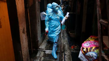 Healthcare workers enter a resedential area to check residents during a nationwide lockdown to slow the spreading of the coronavirus in Mumbai, India. (Reuters)