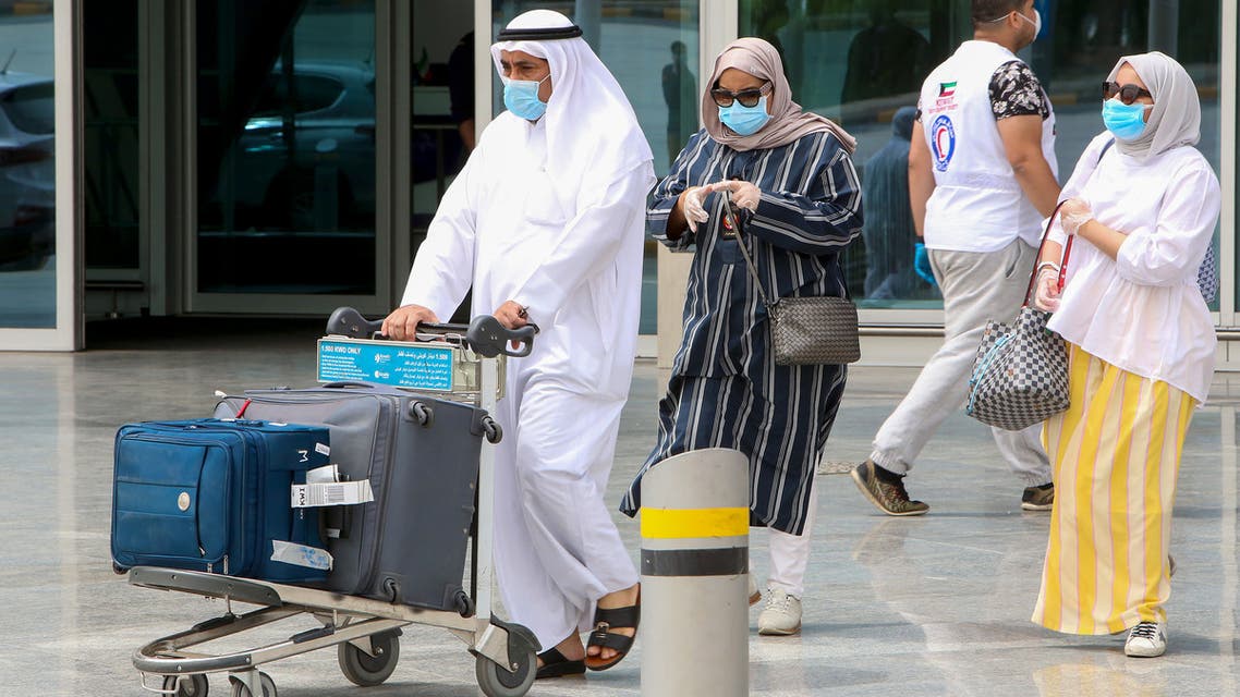 A Kuwaiti national, residing abroad, leaves the Kuwait International airport in the capital upon her return as part of a repatriation plan on April 19, 2020, and ahead of being taken to mandatory home quarantine.
