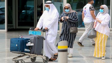 A Kuwaiti national, residing abroad, leaves the Kuwait International airport in the capital upon her return as part of a repatriation plan on April 19, 2020, and ahead of being taken to mandatory home quarantine. 