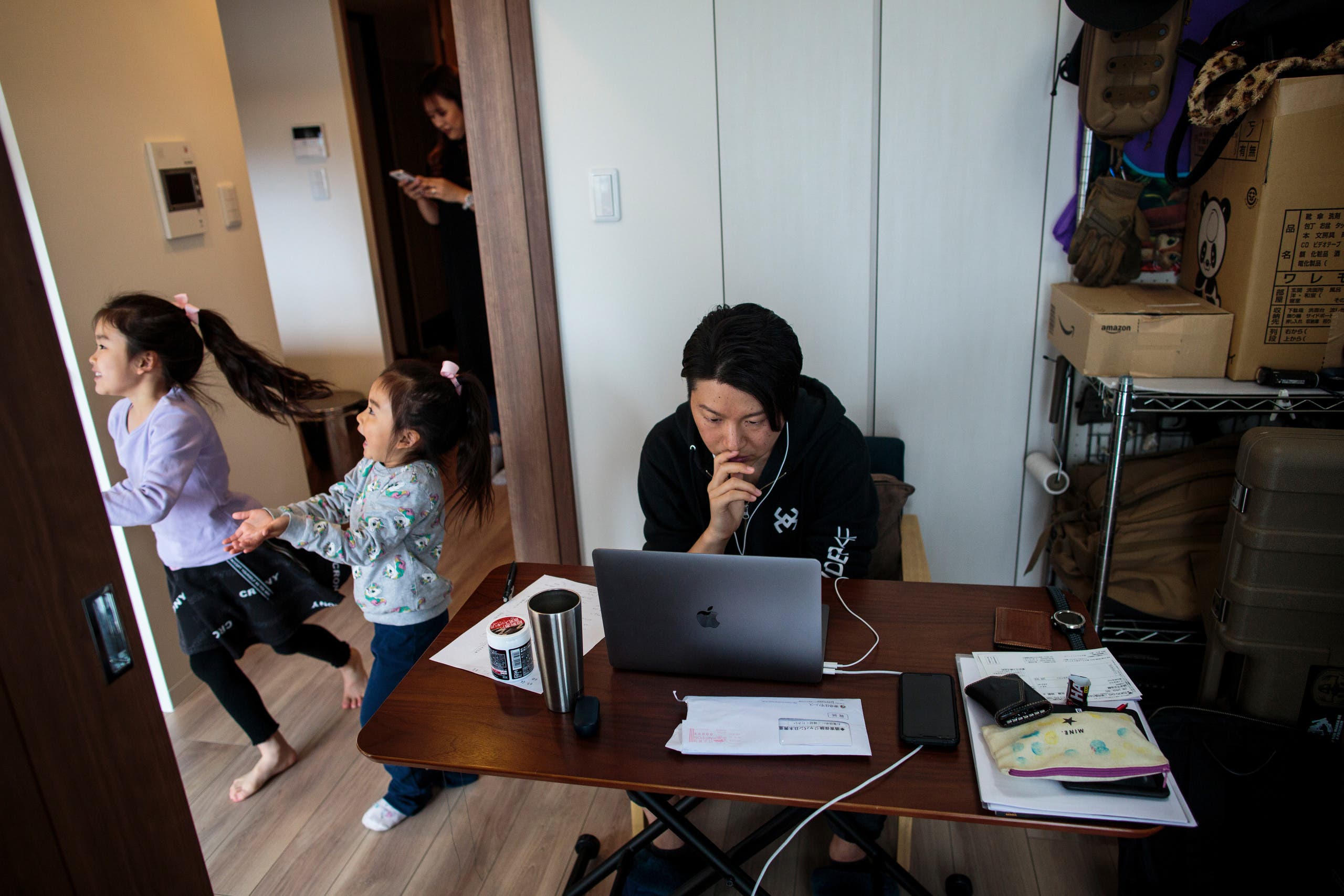This picture taken on March 23, 2020 shows Yuki Sato, an employee in a startup company, working from home as a result of the COVID-19 novel coronavirus in Tokyo. (AFP)