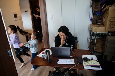 This picture taken on March 23, 2020 shows Yuki Sato, an employee in a startup company, working from home as a result of the COVID-19 novel coronavirus in Tokyo. (AFP)