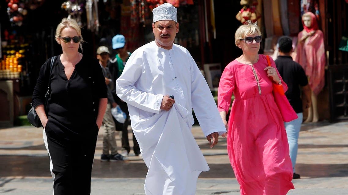 People walk on a street on March 18, 2015 in the Omani capital, Muscat. (AFP)