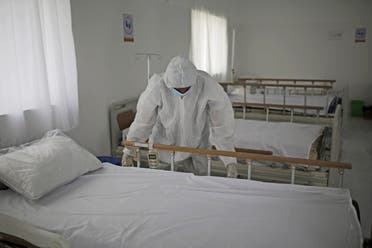 A medical staff member adjusts the sheets on a bed as personnel setup a coronavirus quarantine ward at a hospital in Sanaa, Yemen on March 15, 2020. (AP)