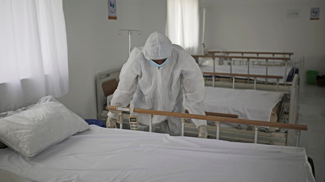 A medical staff member adjusts the sheets on a bed as personnel setup a coronavirus quarantine ward at a hospital in Sanaa, Yemen on March 15, 2020. (AP)