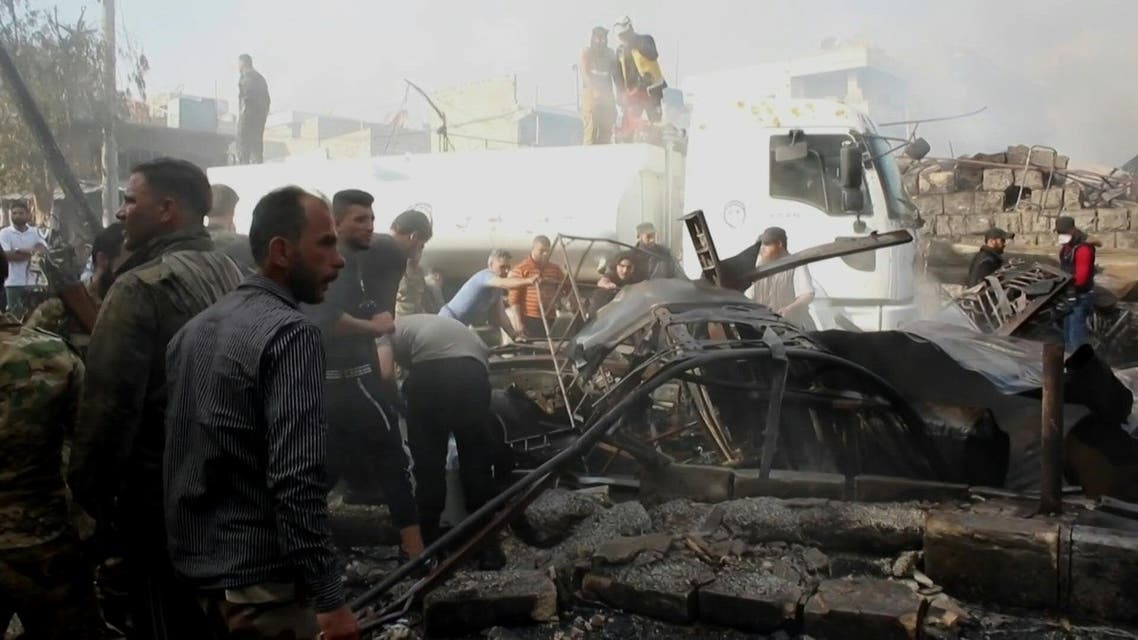 Members of the Syrian Civil Defence, also known as White Helmets, put out fires and evacuate people at the scene of a fuel truck bomb that killed 36 people including at least six Turkey-backed rebel fighters in the northern Syrian city of Afrin. (AFP)