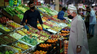 A Bahraini man wears a protective face mask following the outbreak of the coronavirus disease (COVID-19), as he shops at a vegetables market ahead of the holy month of Ramadan in Manama, Bahrain, April 23, 2020. REUTERS/Hamad I Mohammed