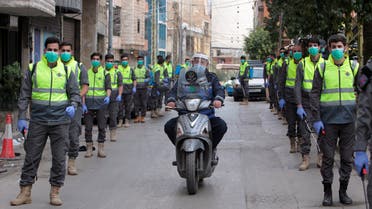 Volunteers from Hezbollah's Islamic health unit stand in preparation to sanitize streets as precaution against the spread of coronavirus disease (COVID-19), during a media tour organised by Hezbollah officials in Beirut's southern suburb. (Reuters)