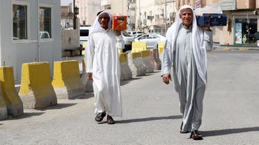 Men carry food after Saudi Arabia imposed a temporary lockdown on the province of Qatif, following the spread of coronavirus, in Qatif. (File photo: Reuters)