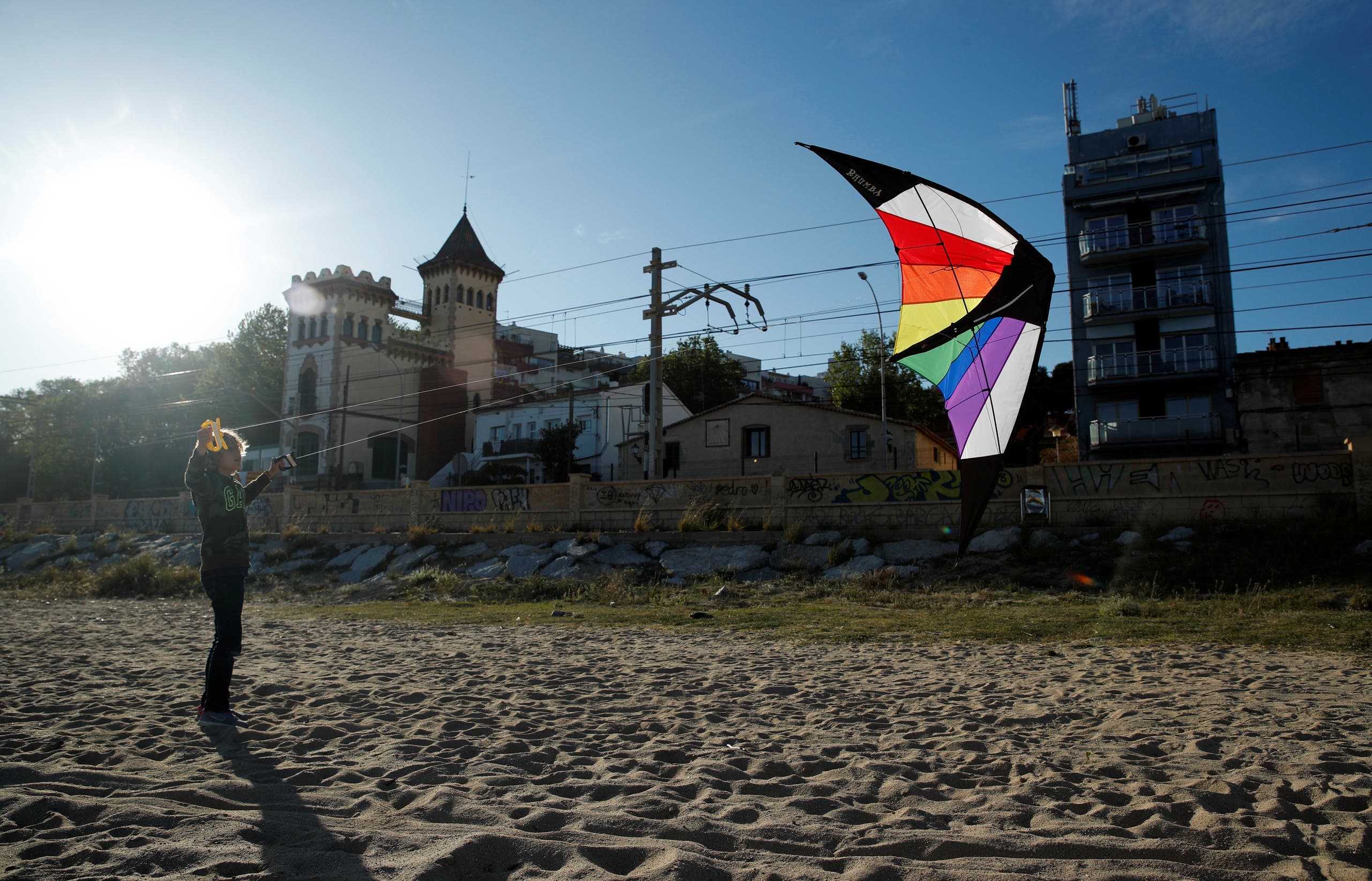 A boy flies a kite on a beach, after restrictions were partially lifted for children, following the coronavirus disease (COVID-19) outbreak in El Masnou, north to Barcelona, Spain, April 29, 2020. (Reuters)