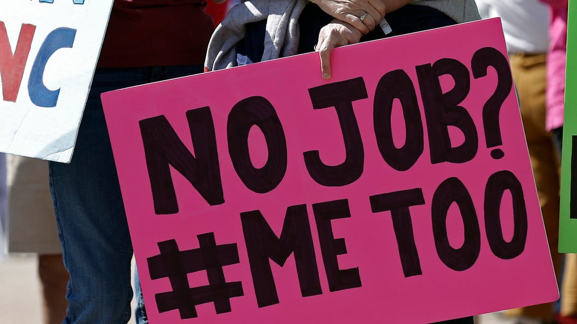 In this photo taken Tuesday, April 28, 2020 in Raleigh, N.C. a woman holds a no job sign during a rally near the General Assembly. (AP)