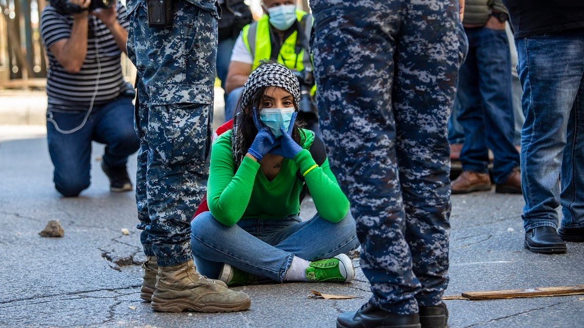 An anti-government protester blocks a road during May Day protest near the Lebanese Central Bank in Beirut, Lebanon, Friday, May 1, 2020. (AP)