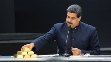 Venezuela's President Nicolas Maduro touches a gold bar as he speaks during a meeting with the ministers responsible for the economic sector at Miraflores Palace in Caracas, Venezuela, March 22, 2018. (Reuters)