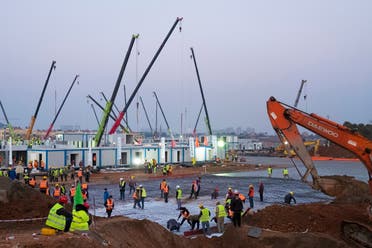 Construction workers labor at the site of the Huoshenshan temporary field hospital being built in Wuhan in central China's Hubei Province, on January 30, 2020. (AP)