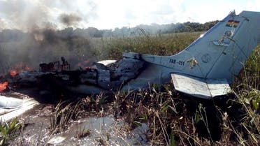 The remains of an aircraft from the Bolivian Air Force burn after crashing near Trinidad, Bolivia, Saturday, May 2, 2020. The plane, flying a humanitarian mission, crashed minutes after takeoff in the Amazonian region, killing all six occupants, including four Spaniards who were being ferried to catch a flight to their homeland, the Defense Ministry said Saturday. (AP Photo/Kevin Bustamante)