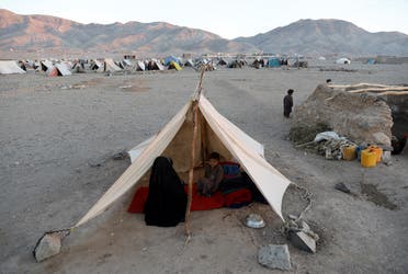 Internally displaced Afghan family sits inside a tent at a refugee camp in Herat province, Afghanistan. (Reuters)