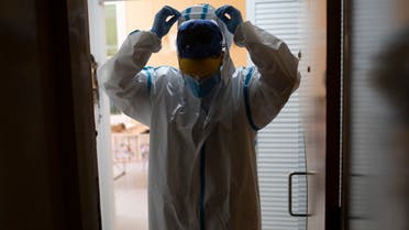 A medic from the CAP Manso primary care center leaves after visiting a coronavirus patient at his home in Barcelona on May 1, 2020. (Josep Lago/AFP)