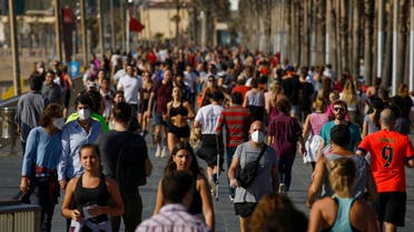 People exercise on a seafront promenade in Barcelona, Spain, on Saturday, May 2, 2020. (AP)