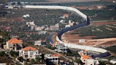 Houses and cars are seen in the Lebanese village of Adaisseh next to the Lebanese-Israeli border, August 26, 2019. (Reuters)