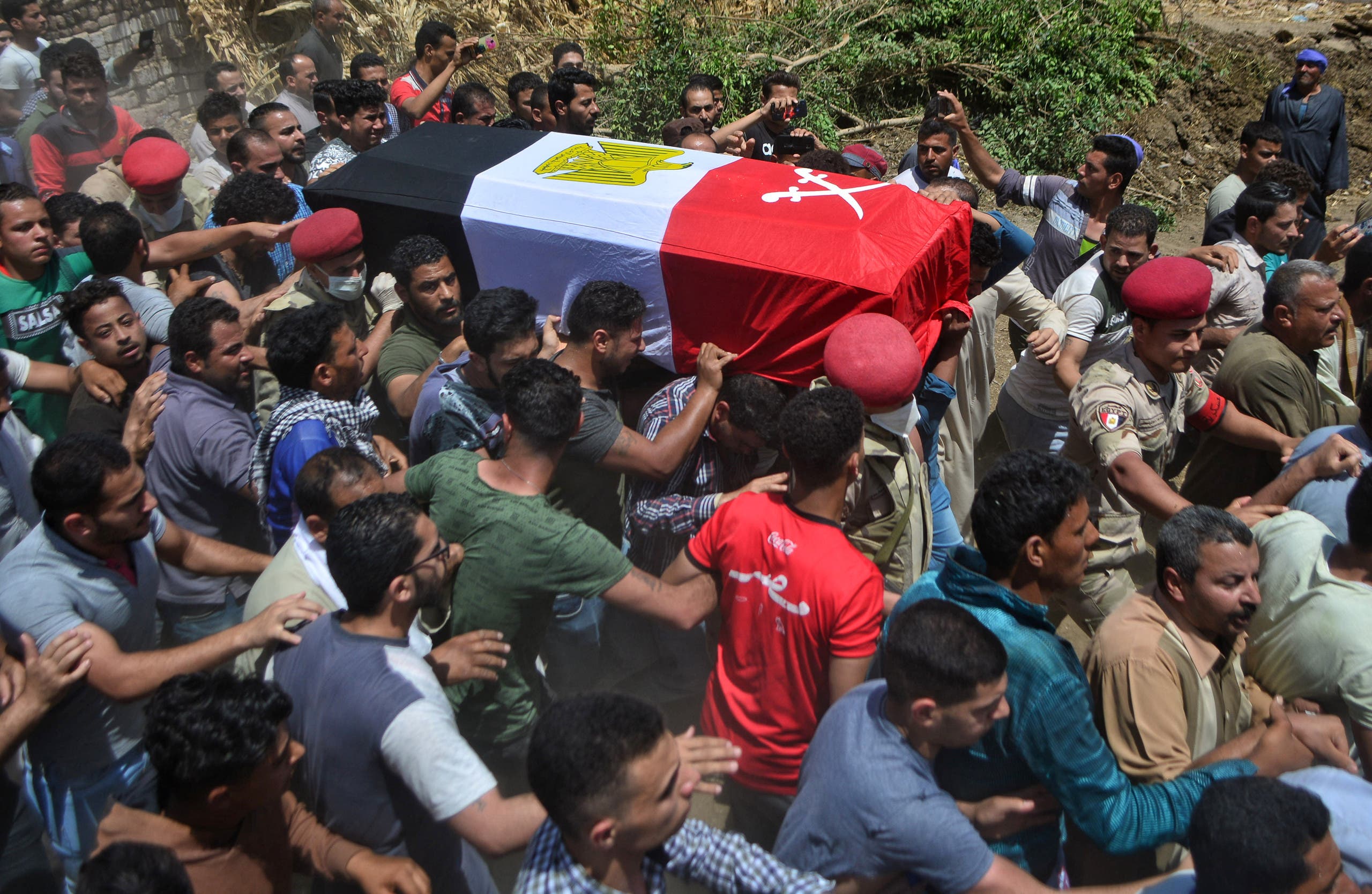 Mourners carry the coffin of Egyptian soldier Alaa Emad during his funeral in the village of Abwan in the Minya province on May 1, 2020, as his body was returned after he was killed in an explosion targeting an armored vehicle near Bir al-Abed in North Sinai. (AFP)