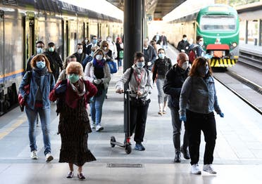 People wearing face masks arrive at the Cadorna railway station, as Italy begins a staged end to a nationwide lockdown due to the spread of the coronavirus, in Milan, Italy, on May 4, 2020. (Reuters)