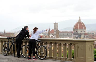 People enjoy the view of Florence from Piazzale Michelangelo in Florence, Italy, May 1, 2020. (Reuters)