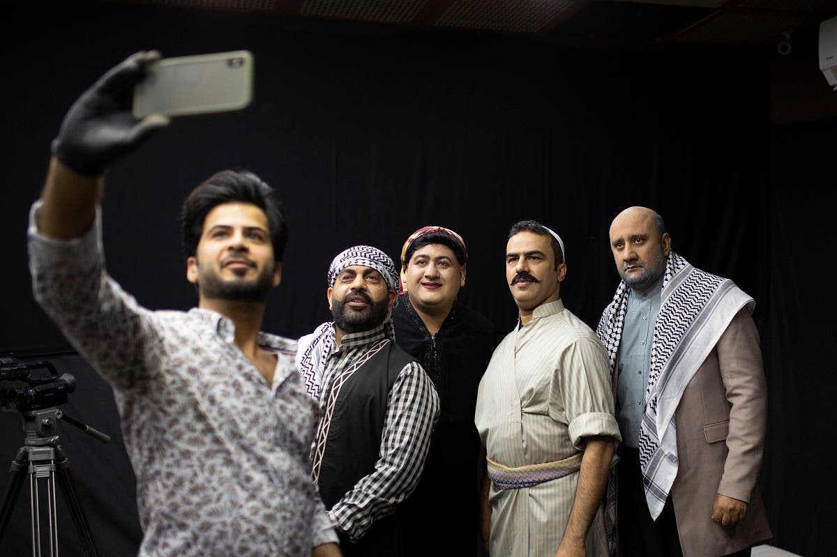 The set's makeup artist (L) takes a selfie photograph as he poses with Iraqi actors (L to R) Ayad al-Atabi, Oussama Mahdi, Youssef al-Hajjaj, and Mohammad Qassem on the set of a parody sketch video of Bab al-Hara, an adaptation of an iconic long-running Syrian television drama, in Iraq's southern port city of Basra. (AFP)