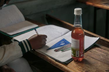 A bottle of Madagascar’s herbal coronavirus ‘cure’ sits on a schoolchild’s desk. (AFP)
