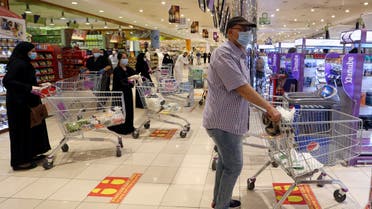 People follow social distancing markings as they line up at a shopping mall after the Saudi government eased a curfew and allowed stores to open, following the outbreak of the coronavirus disease (COVID-19), in Riyadh, Saudi Arabia May 2, 2020. REUTERS/Ahmed Yosri