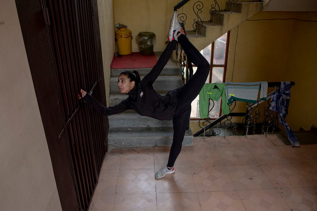 Kashmiri Taekwondoin Afreen Hyder practises in her apartment's corridor in Srinagar, Indian controlled Kashmir, April 19, 2020. (AP)