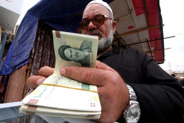 A man buys Iranian rials from a seller of Iranian currency, before the start of the US sanctions on Tehran, in Basra, Iraq. (File photo: Reuters)