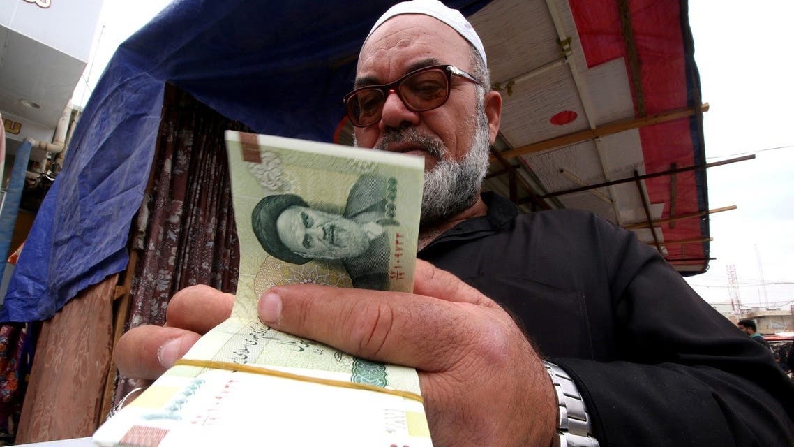 A man buys Iranian rials from a seller of Iranian currency, before the start of the U.S. sanctions on Tehran, in Basra. (File photo: Reuters)